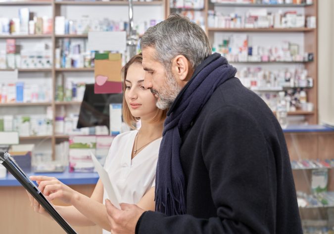 Apotheco Tools - Drugstore specialist showing folder to customer